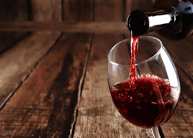 wine poured from a bottle into a glass