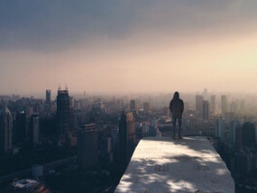a man standing in front of a city view
