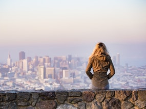 a woman sitting in front of a city view